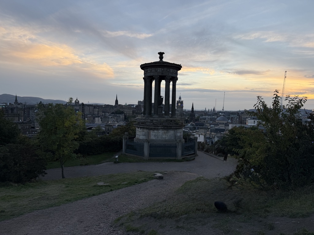The Dugald Stewart Monument on Carlton Hill overlooking Edinburgh at sunset.